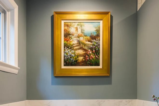 A painting in a bathroom illuminated by accent lighting
