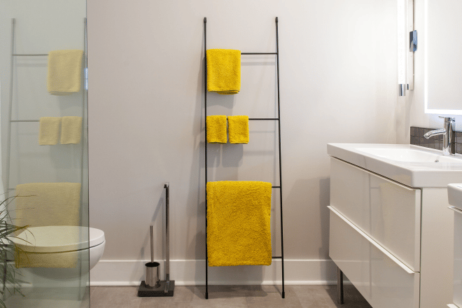 A towel rack and other bathroom accessories in a bathroom remodeled by Ranney Blair