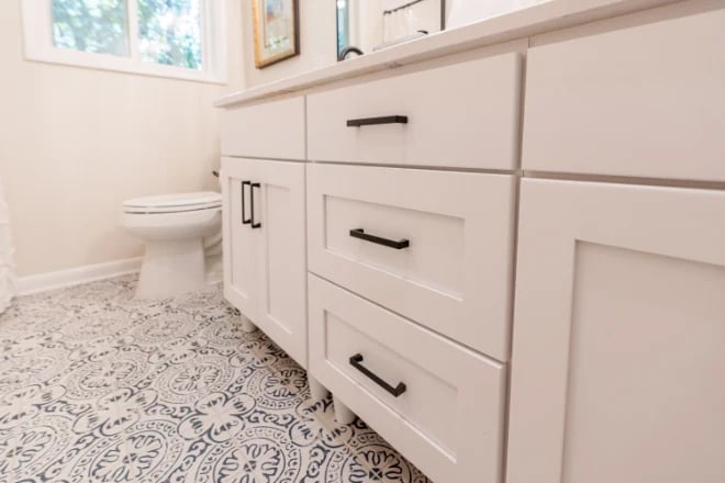 Graphic floor tiles in a bathroom remodeled by Ranney Blair Weidmann