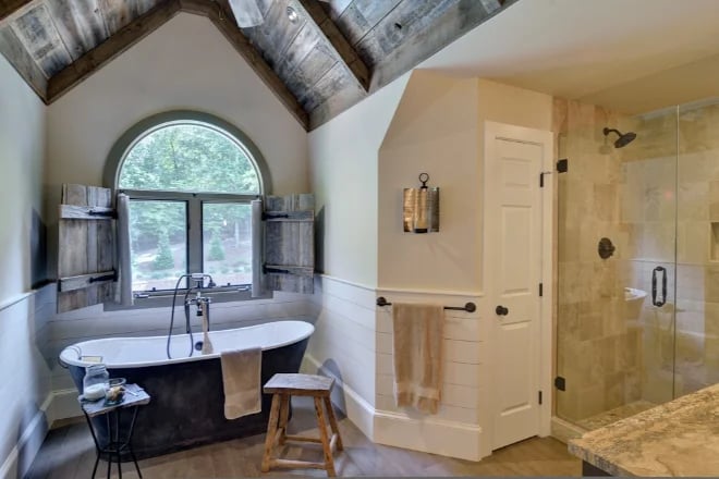 A bathroom with classic wooden shutters for maximum privacy when needed