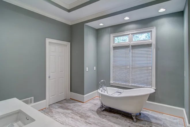 A bathroom with honeycomb shades as a window treatment, also known as cellular shades