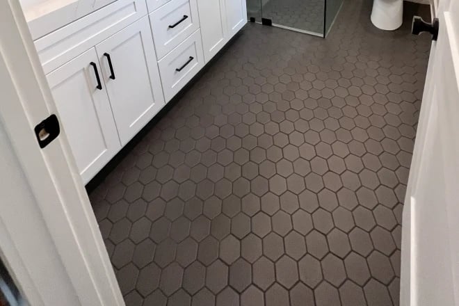 A black tile floor in a bathroom