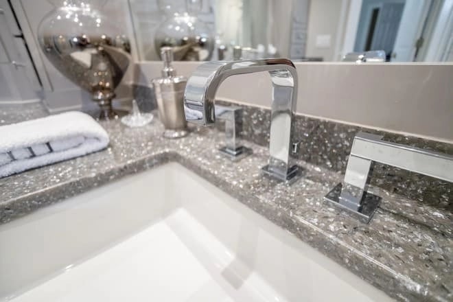 A chrome, 3 hole faucet in a recently remodeled bathroom