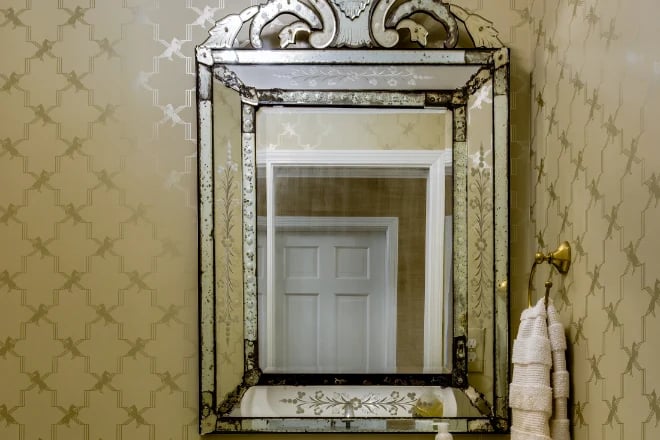 A fancy antique mirror complements the decor of this bathroom