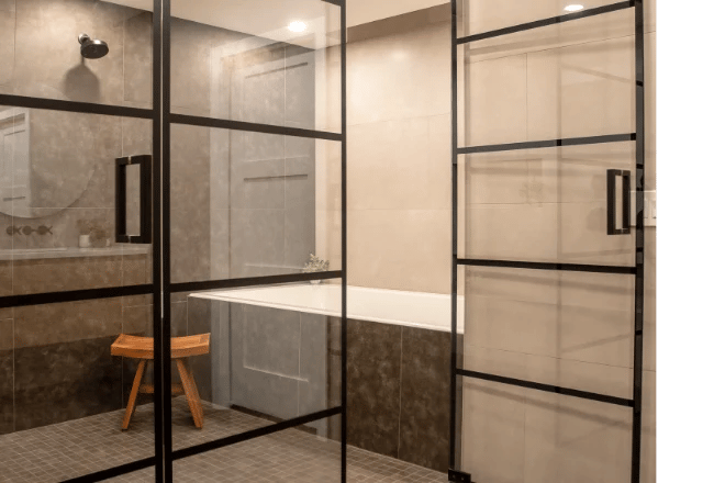 A luxury bathroom featuring a high-end framed shower enclosure