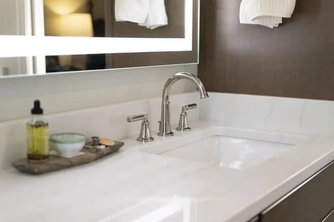 A quartz bathroom countertop provides a solid color for you to match your bathroom color scheme to