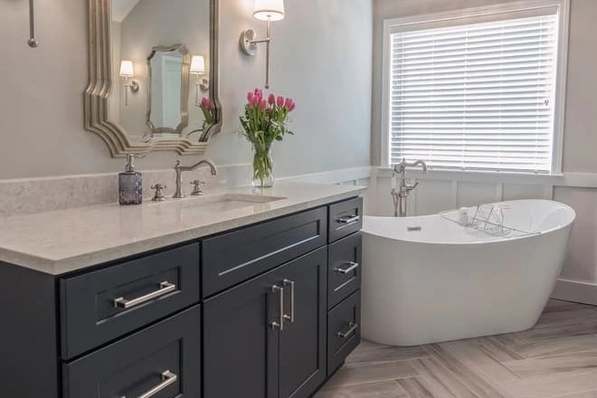 A quartz bathroom countertop provides color scheme consistency in this bathroom remodel