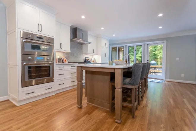 A spacious kitchen with natural wood floors
