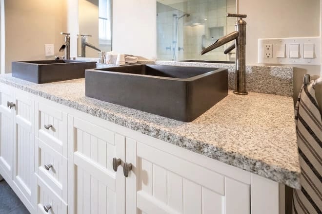 An unusual faucet design that complements the vessel sinks in this bathroom remodel