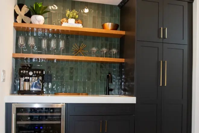 Floating shelves and a countertop above a wine fridge