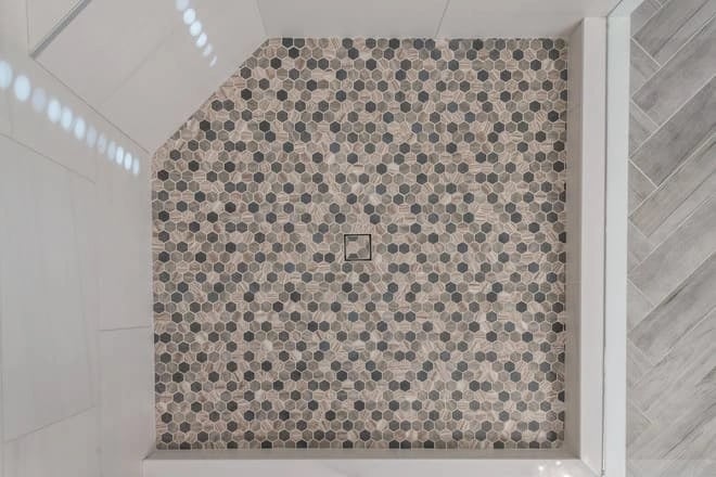 Intricate tile work adds an elegant touch to this shower area