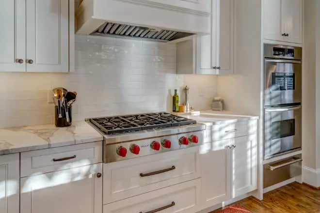 Multiple ovens and a range hood visible in this luxury kitchen