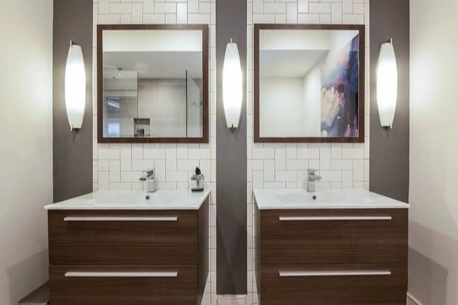 Two bathroom vanities with solid surface countertops