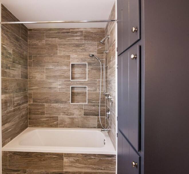 A shower featuring wood-look tile work.