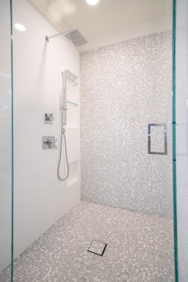 A shower with a statement tile mosaic wall.