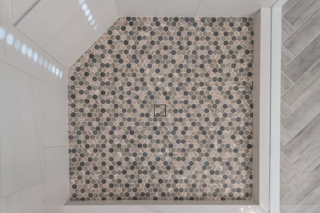 A hexagon tile shower floor.