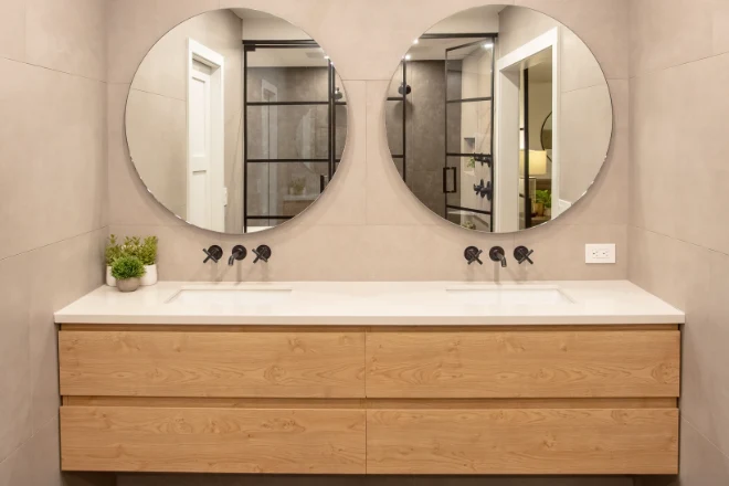 A custom double-sink floating vanity with two mirrors