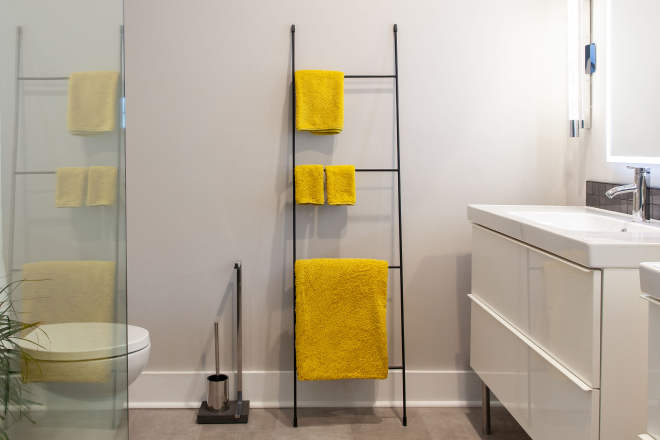 A towel rack and other bathroom accessories in a bathroom remodeled by Ranney Blair