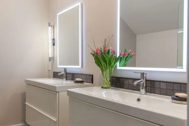 Beautiful white double vanity installed by Ranney Blair