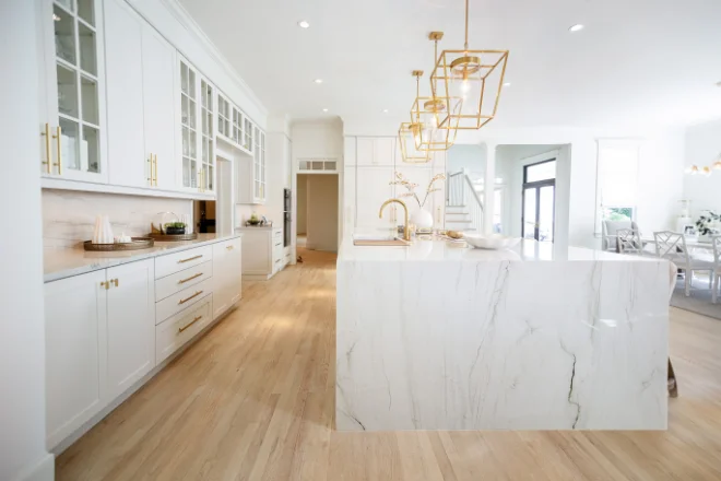 Hardwood kitchen flooring in a kitchen with a waterfall island