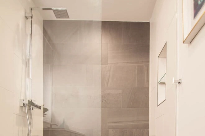 A bathroom shower enclosure with premium glass
