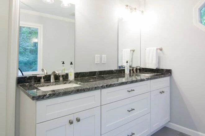 A bathroom vanity with cultured marble countertops