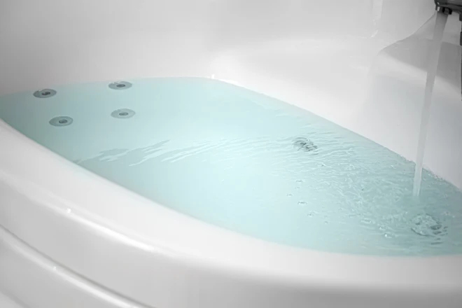 A bathtub with jets underwater visible