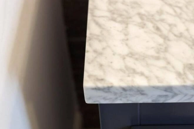 A close up of a marble bathroom countertop corner