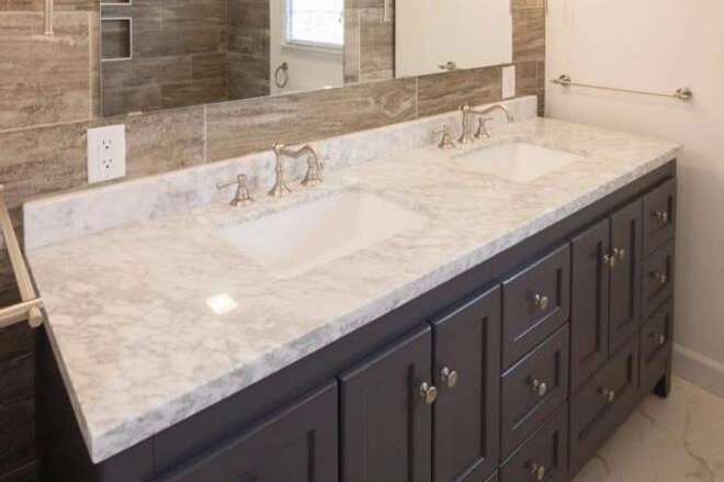 A double sink vanity with a granite bathroom countertop