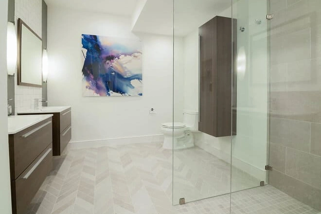 A glass shower enclosure in a contemporary design bathroom