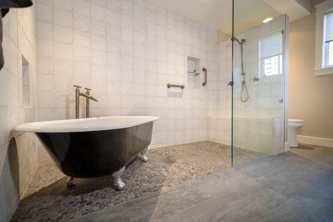 A luxury bathroom remodel by Ranney Blair, featuring limestone tile