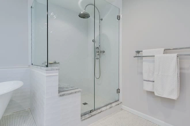 A luxury bathroom with a glass shower enclosure