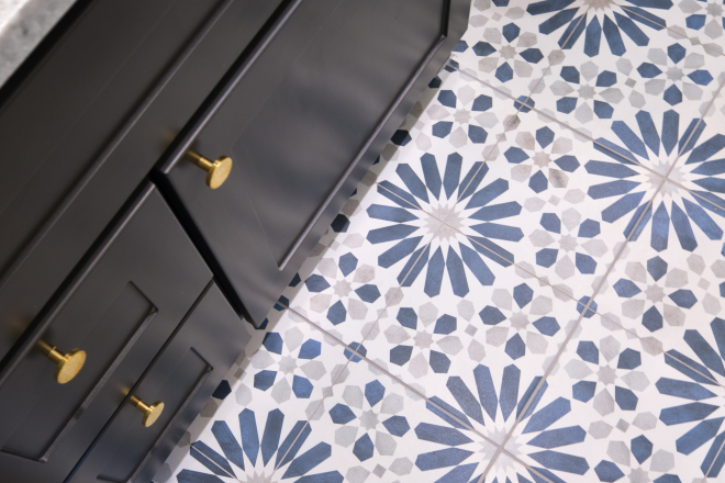 Detail of bathroom vanity and floor with starburst design tiles