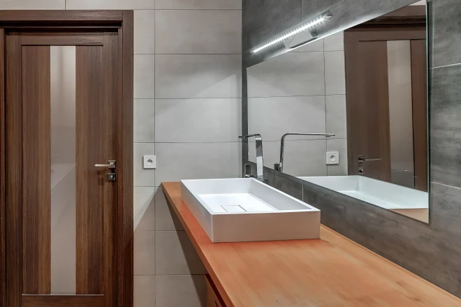 Wood countertops in a modern bathroom with a vessel sink
