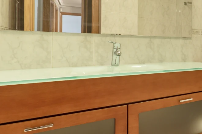 bathroom vanity with a tempered glass countertop
