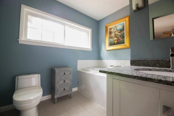 A beautifully remodeled bathroom featuring new floor tiles.