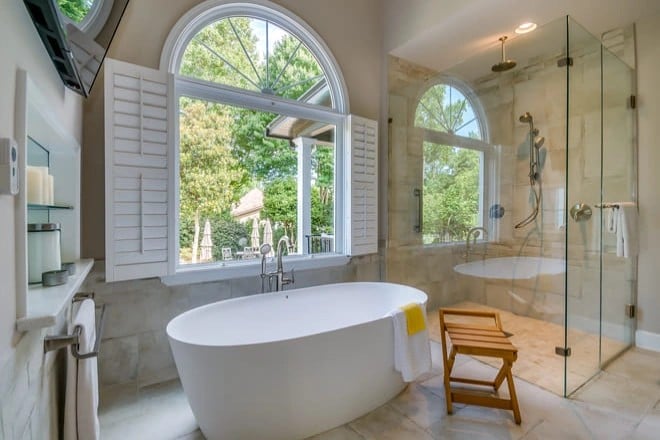 A beautifully remodeled bathroom with a freestanding tub and new flooring.