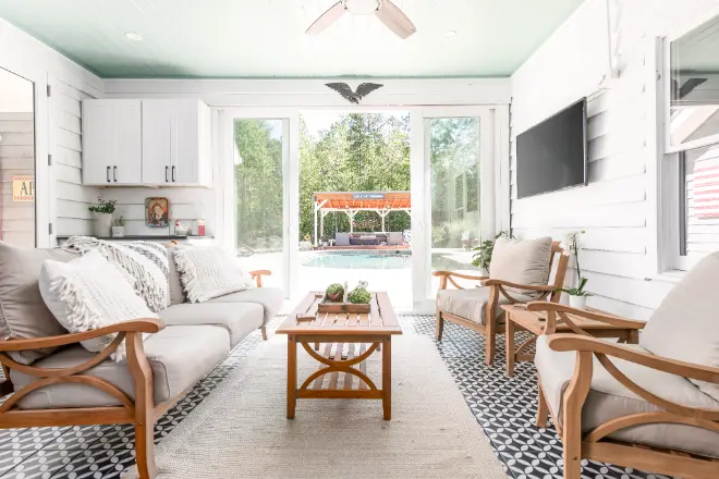 A sunroom with doors leading into the outdoors